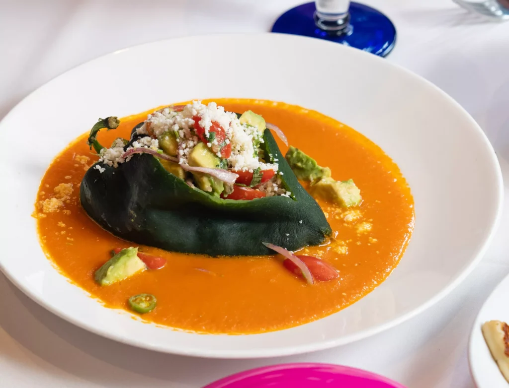 a white dish on a plate showing chile relleno
