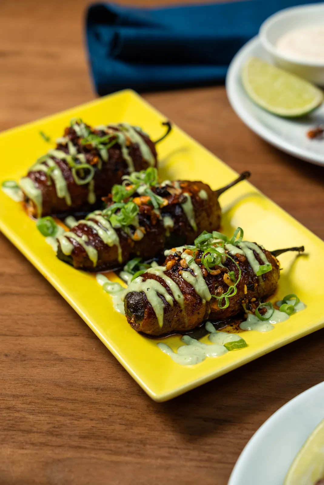 Jalapeños Rellenos de Birria topped with tomatillo avocado crema and scallions, from the Rosa Mexicano fall menu